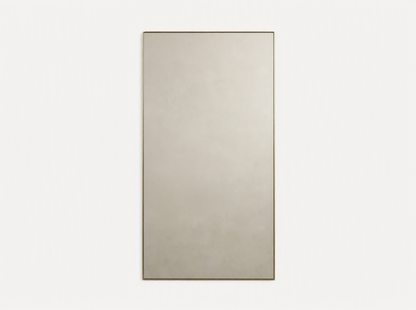 Lira Rectangular Bath Wall Mirror with a thin brass frame, hanging vertically against a neutral beige wall.
