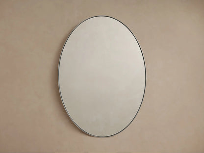 Oval wall mirror with a sleek nickel frame, reflecting a soft, neutral-colored wall backdrop.
