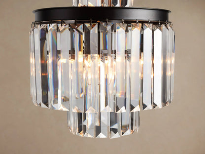 Leyland Chandelier: Multi-tiered fixture with an oil-rubbed black iron frame and clear faceted K9 glass crystals, illuminated.