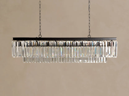 Leyland Tiered Rectangular Chandelier: dark frame with two tiers of glowing K9 clear glass crystals, hanging from chains.