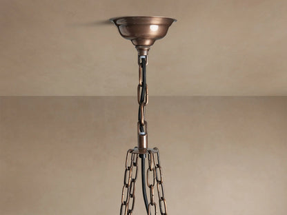 Laila Round Chandelier, antique copper frame with staggered, distressed mirrored-glass panels casting a warm golden light.