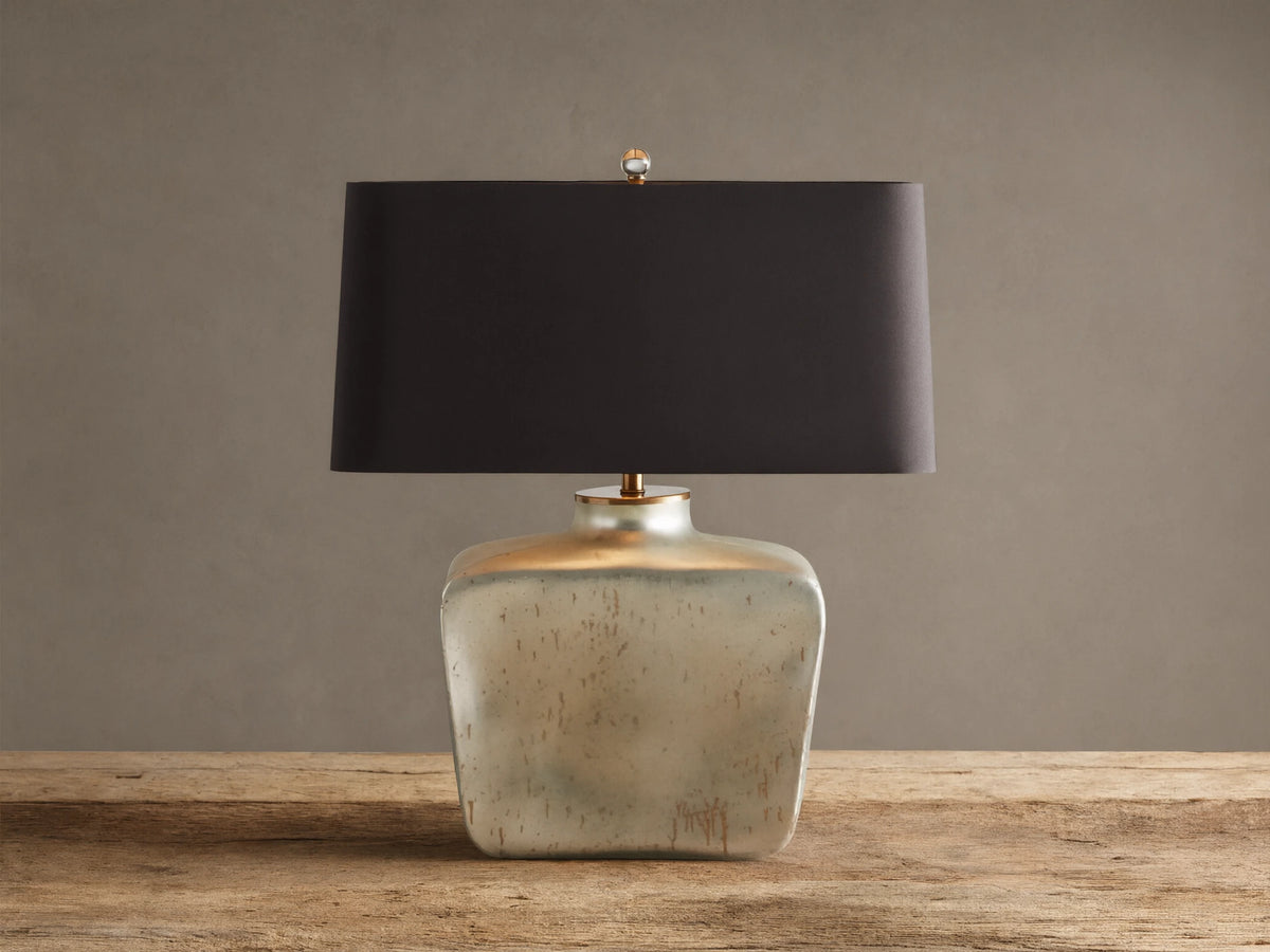 Balor Table Lamp: rectangular black shade, shimmering Antique Silver Rain glass base, gold finial, on wood.