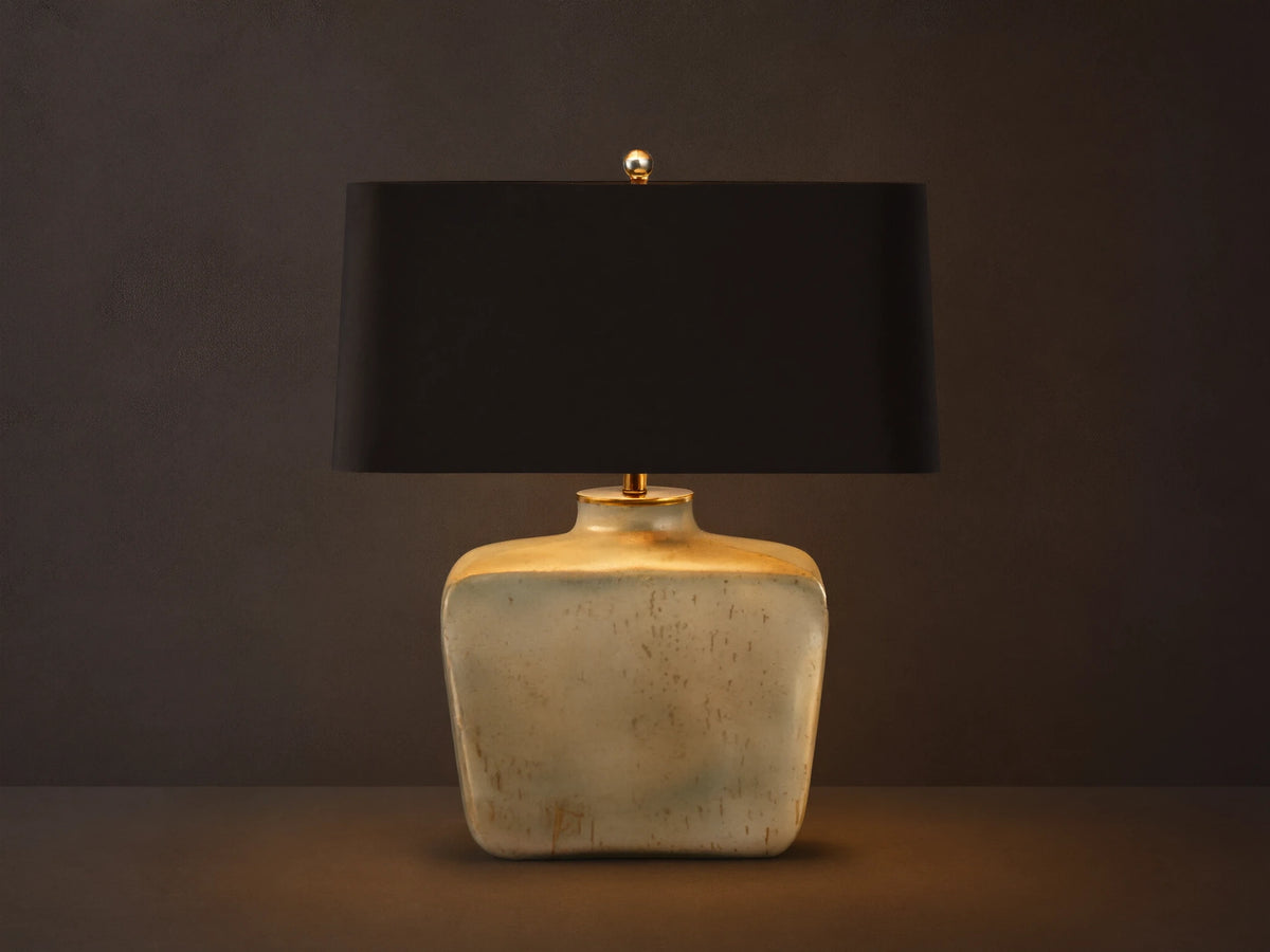 Balor Table Lamp: rectangular black shade, shimmering Antique Silver Rain glass base, gold finial, on wood.