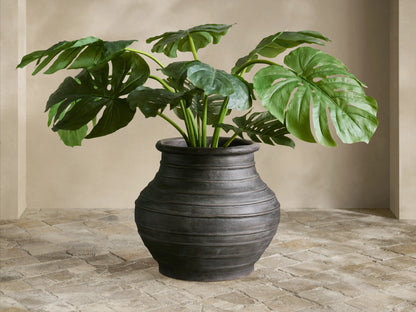 Close-up of an Artem Outdoor Planter with a weathered, dark bronze crackled finish, ribbed body, and a rolled rim.