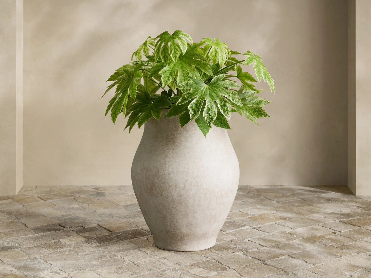 Close-up of Gable Outdoor Planter's curved rim & side, revealing its weathered, cracked, light beige terracotta-like finish.