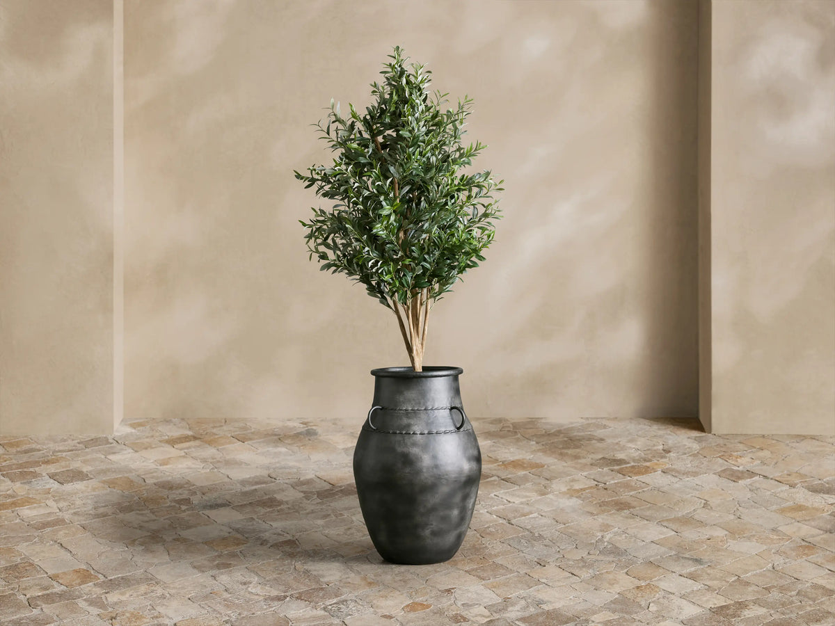 Close-up of dark gray Ilya Wide Outdoor Planter with textured aged metal finish, rounded handles & braided decorative bands.