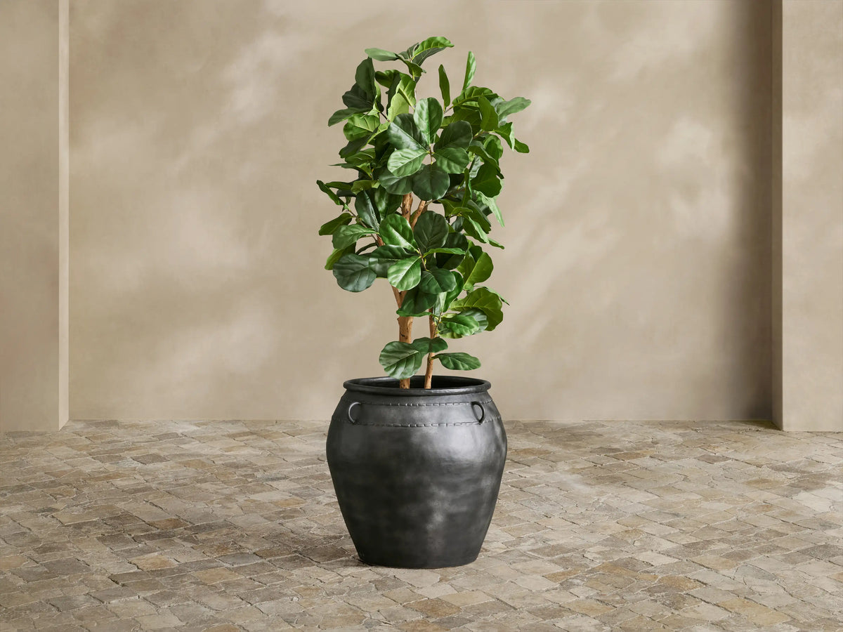 Close-up of dark charcoal Ilya Outdoor Planter, showing aged metal texture, embossed horizontal band, and a single C-ring.