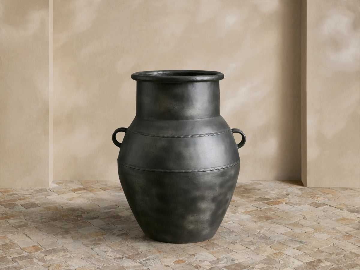 Ilya Outdoor Planter: large, dark charcoal aluminum, aged patina, rounded shape, handles, textured horizontal bands.