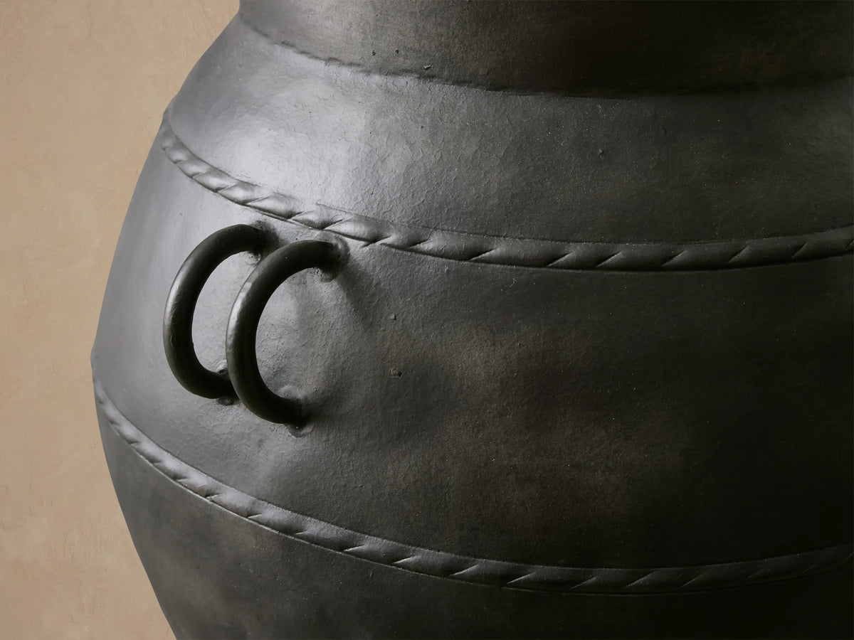 Ilya Outdoor Planter: large, dark charcoal aluminum, aged patina, rounded shape, handles, textured horizontal bands.