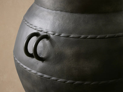Ilya Outdoor Planter: large, dark charcoal aluminum, aged patina, rounded shape, handles, textured horizontal bands.