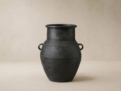 Ilya Outdoor Planter: large, dark charcoal aluminum, aged patina, rounded shape, handles, textured horizontal bands.