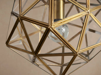 Eliana Lantern Pendant, a golden brass geometric faceted light fixture with clear glass panels, hanging from a chain.