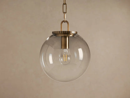 Wescott Globe Pendant: clear glass sphere with brass hardware and visible Edison bulb, hanging from a chain.