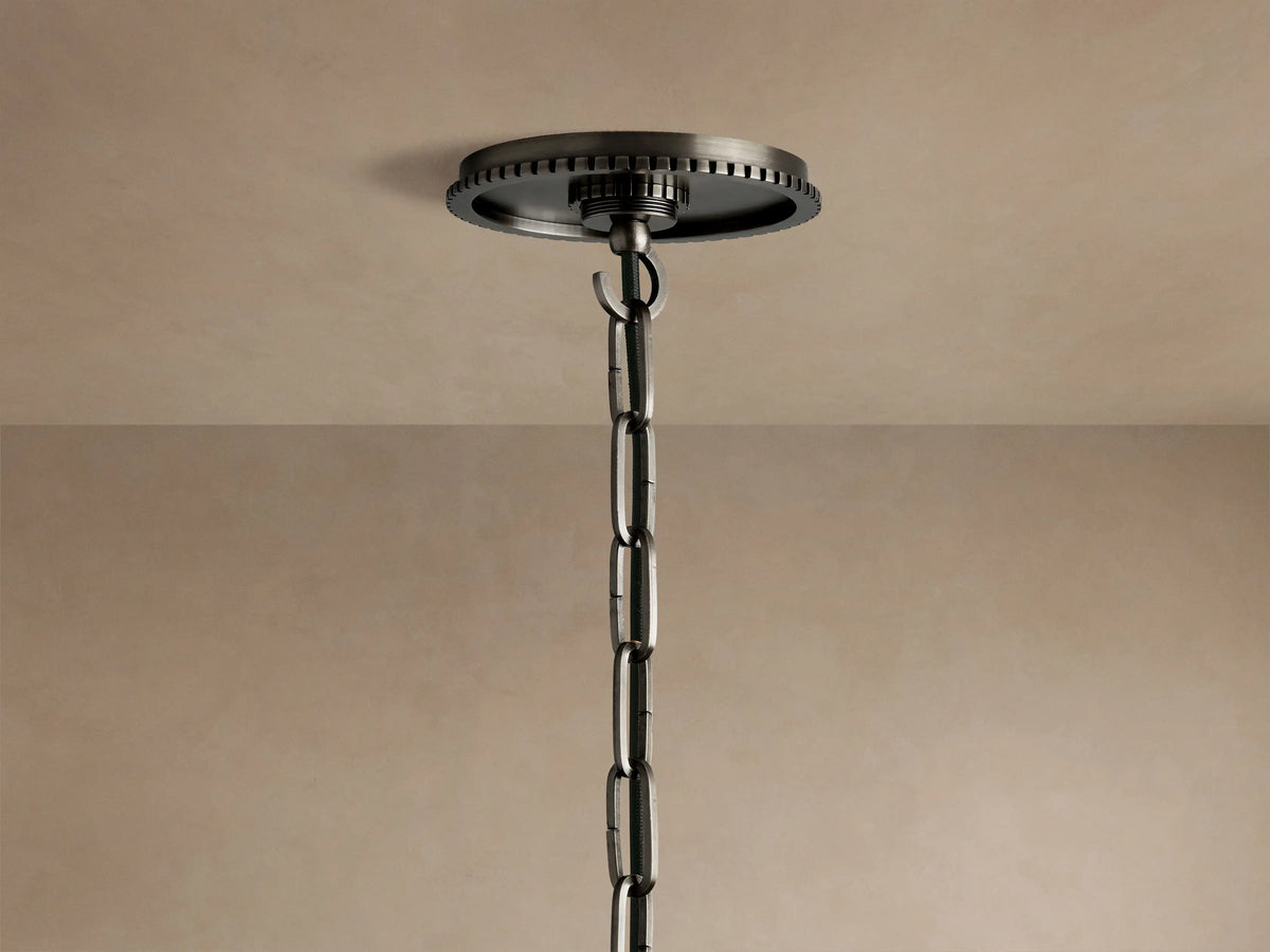 Close-up of Wescott Globe Pendant in dark bronze with ribbed detail, holding a clear glass globe and visible light bulb.