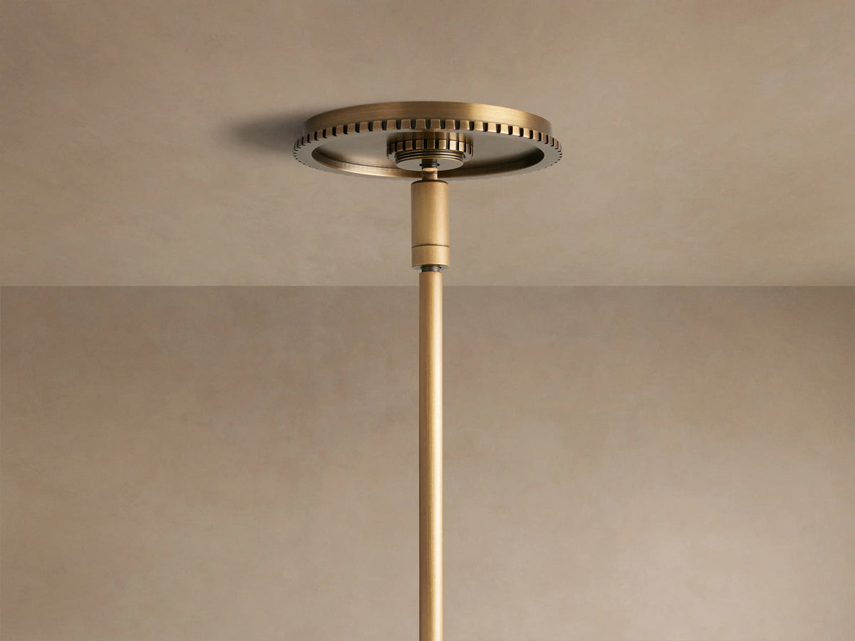 Close-up of Wescott Globe Pendant with brass rod, textured ring, & clear glass globe.