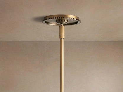 Close-up of Wescott Globe Pendant with brass rod, textured ring, & clear glass globe.