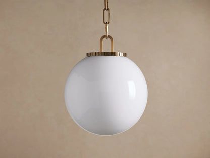 Wescott Globe Pendant with Chain; a white milk glass globe hangs from a brass chain and ribbed brass fixture.