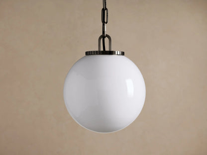 Wescott Globe Pendant: Opaque white glass globe with dark metal chain & fixture, hanging against a plain brown wall.