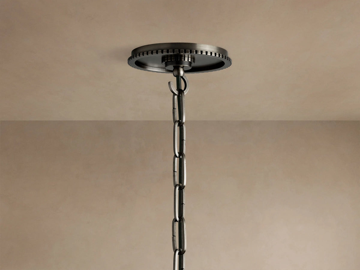 Close-up of a Wescott Globe Pendant showing a smooth white milk glass globe connected to a dark bronze ribbed fixture.
