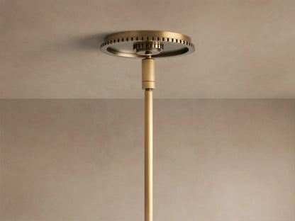 Close-up of Wescott Globe Pendant with Rod; white milk glass globe, ribbed brass finish ring, and a brass rod.