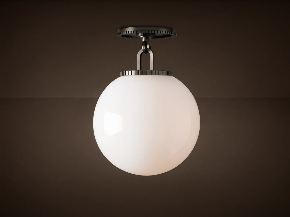 Wescott Globe Flush Mount with opaque white milk glass sphere and dark bronze hardware, against a light brown ceiling.