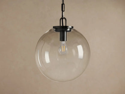 Wescott Globe Pendant with Chain. Large, slightly amber-tinted clear glass globe with dark bronze hardware and exposed bulb.