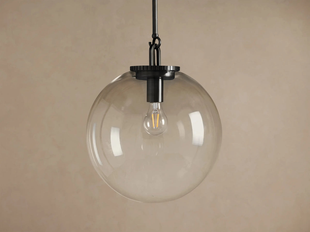 Wescott Globe Pendant with Rod, featuring a large clear glass globe, dark bronze rod, and an exposed filament bulb.