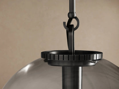 Wescott Globe Pendant with clear glass, dark bronze rod, and visible filament bulb, hanging.