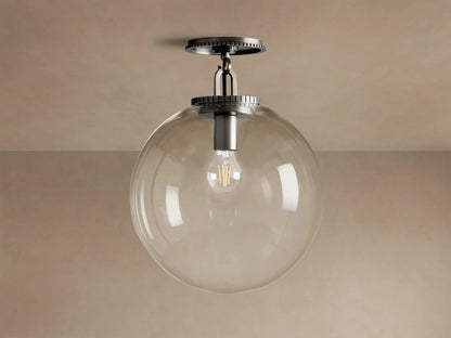 Wescott Globe Flush Mount with clear glass globe, dark bronze hardware, and visible Edison bulb hanging from a ceiling.
