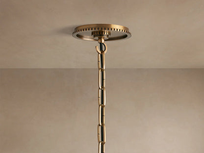 Close-up of Wescott Globe Pendant with a smooth white globe, brass-finished ring with grooved details, and brass rod.