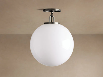 Wescott Globe Flush Mount with a large, white milk glass globe and dark bronze steel hardware, mounted on a light beige ceiling.