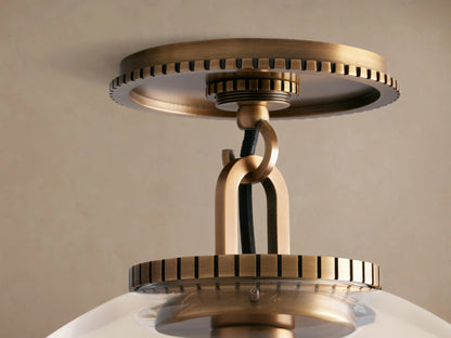 Wescott Globe Flush Mount with a clear glass globe, brass hardware, and a visible Edison bulb, mounted on a ceiling.