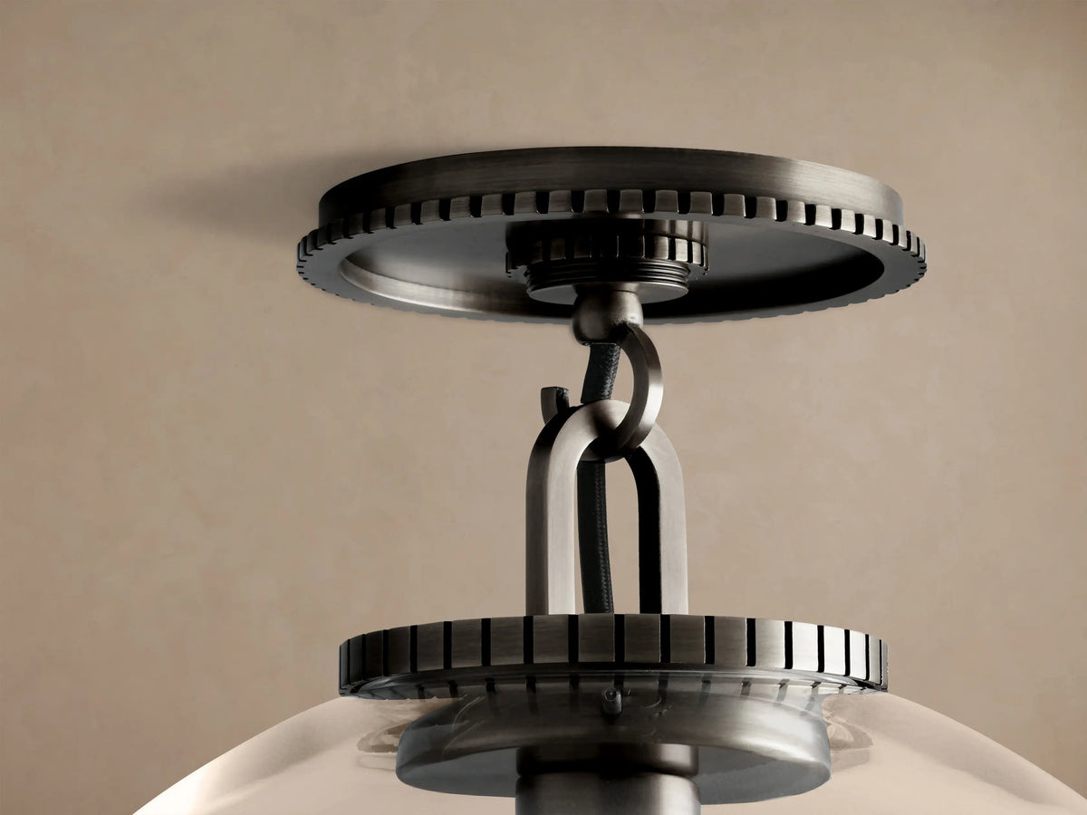 Wescott Globe Flush Mount: large clear glass globe, dark bronze canopy, brass stem, visible warm filament bulb.