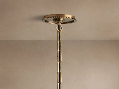 Wescott Globe Pendant: Close-up of a milky white glass globe meeting a brushed brass fitting with a ribbed textured band.