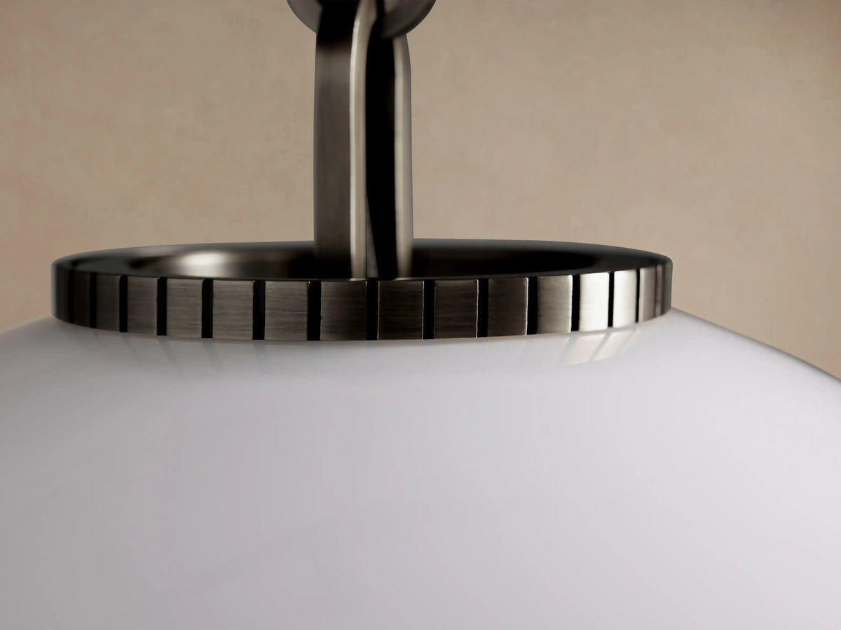 Wescott Globe Pendant with Chain, large white milk glass globe hanging from a dark metal chain against a beige wall.