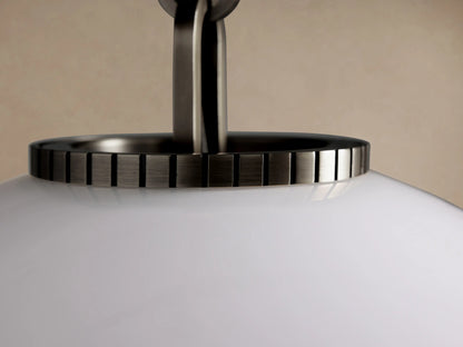 Wescott Globe Pendant with Chain, large white milk glass globe hanging from a dark metal chain against a beige wall.