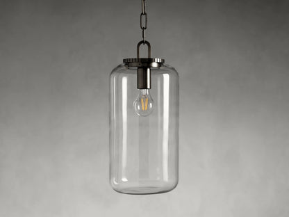 Wescott Cylinder Pendant with brass or bronze finish, clear glass shade, exposed bulb inside; black chain hangs from top.