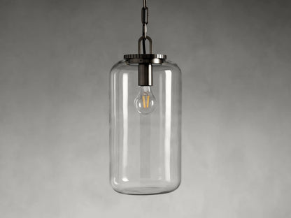 Wescott Cylinder Pendant with a clear glass shade hanging from a chain. Visible interior bulb, steel fixture in dark finish.