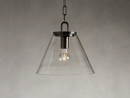 Clear conical glass pendant light with metal fittings in a bronze finish, hanging from a black fabric-wrapped cord and chain.