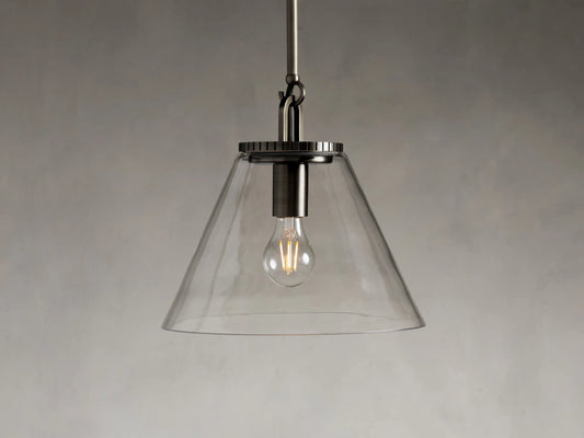 Clear glass cone pendant light with visible bulb, silver metal fixture, and adjustable silver rod on a neutral background.