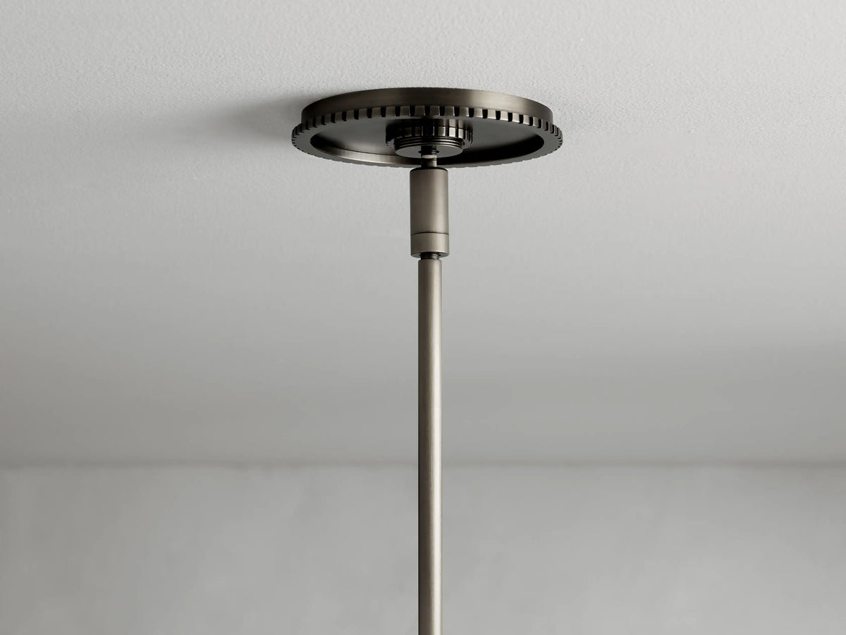 Ceiling-mounted Wescott Cone Pendant rod in a bronze finish, with a decorative round base showcasing detailed edging.