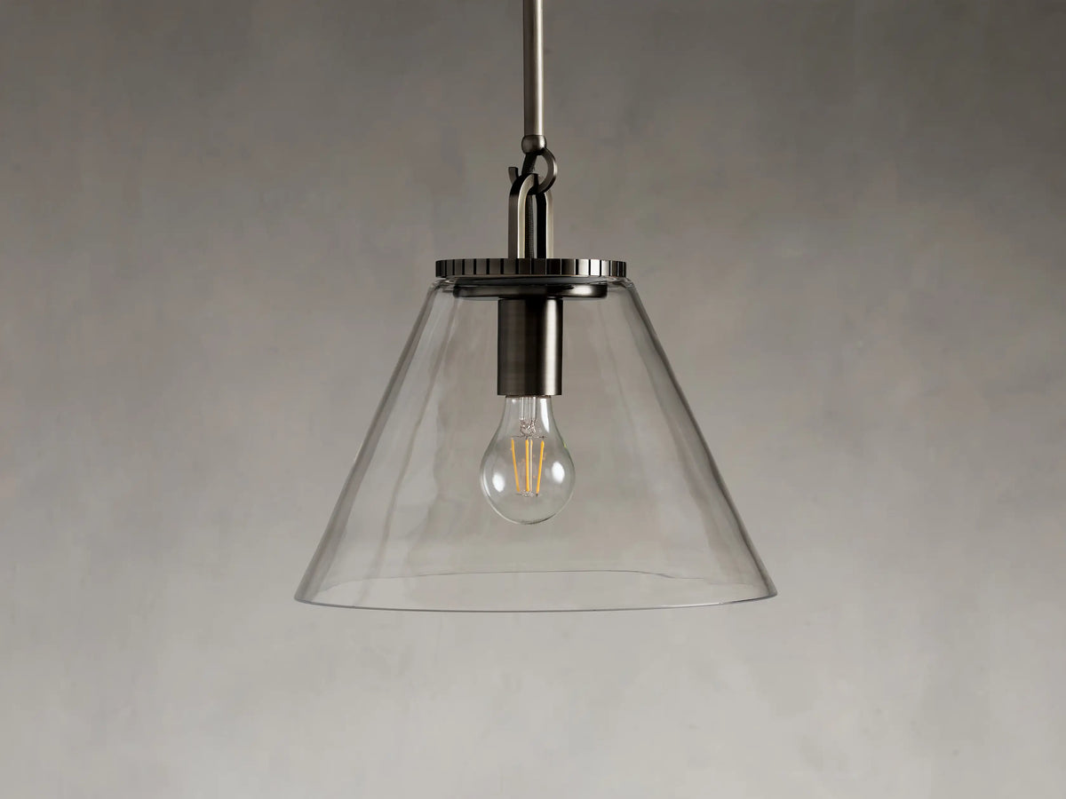 Close-up of the Wescott Cone Pendant in steel with a bronze finish, featuring a clear glass cone and a grooved metal top.
