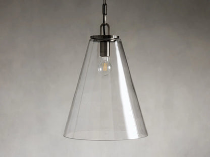 Clear glass cone-shaped pendant light with steel fixture, suspended by a black chain. Single visible bulb interior against a soft gray background.