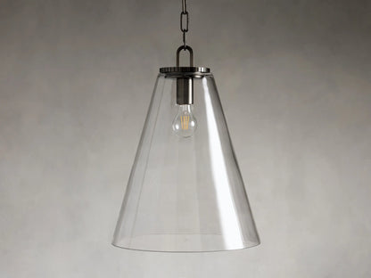 Pendant light with a clear glass cone shade, steel fixture in a brass or bronze finish, hanging from a black chain.
