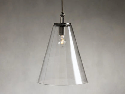 Clear glass cone pendant light with visible bulb and dark metal fixture, suspended from a rod against a gray background.