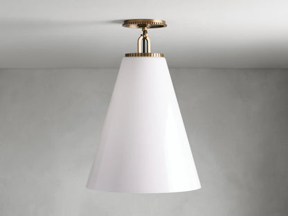 Cone-shaped flush mount light with milk glass shade and brass finish, mounted on ceiling. Matte background.