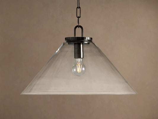 Wescott Cone Pendant: clear glass cone shade, dark bronze finish hardware, and exposed Edison bulb hanging against a tan wall.