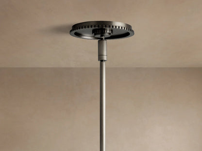 Close-up of Wescott Cone Pendant with dark metal rod, hook, and ribbed circular fixture holding a clear glass shade.