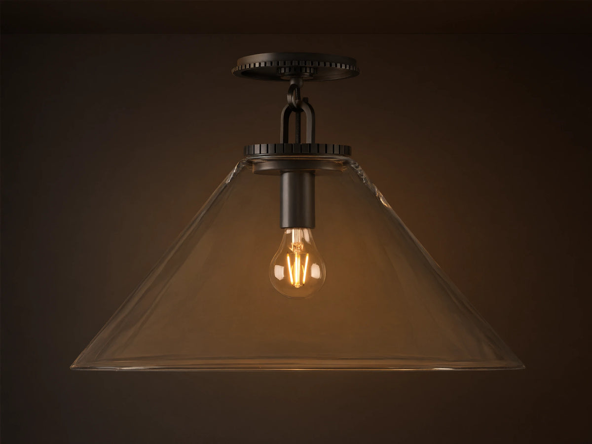 Wescott Cone Flush Mount with dark bronze hardware, clear glass cone shade, and visible Edison bulb, on a tan ceiling.