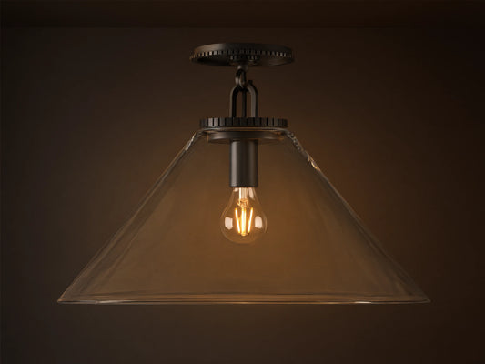 Wescott Cone Flush Mount with dark bronze hardware, clear glass cone shade, and visible Edison bulb, on a tan ceiling.